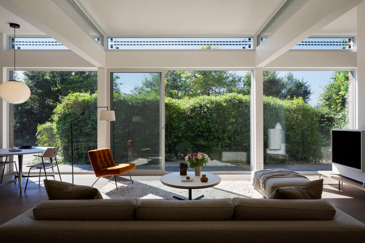 Bright living room kept cooler by solar-control glass in summer