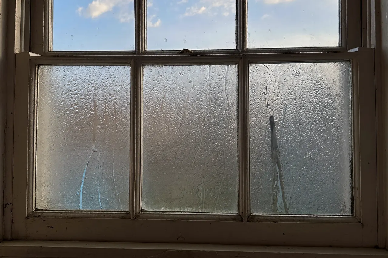 Condensation forming on the inside of an old single-glazed window