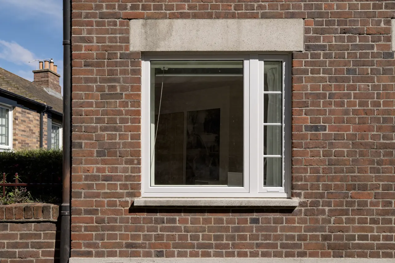 Double-glazed window fitted in a red-brick terraced home