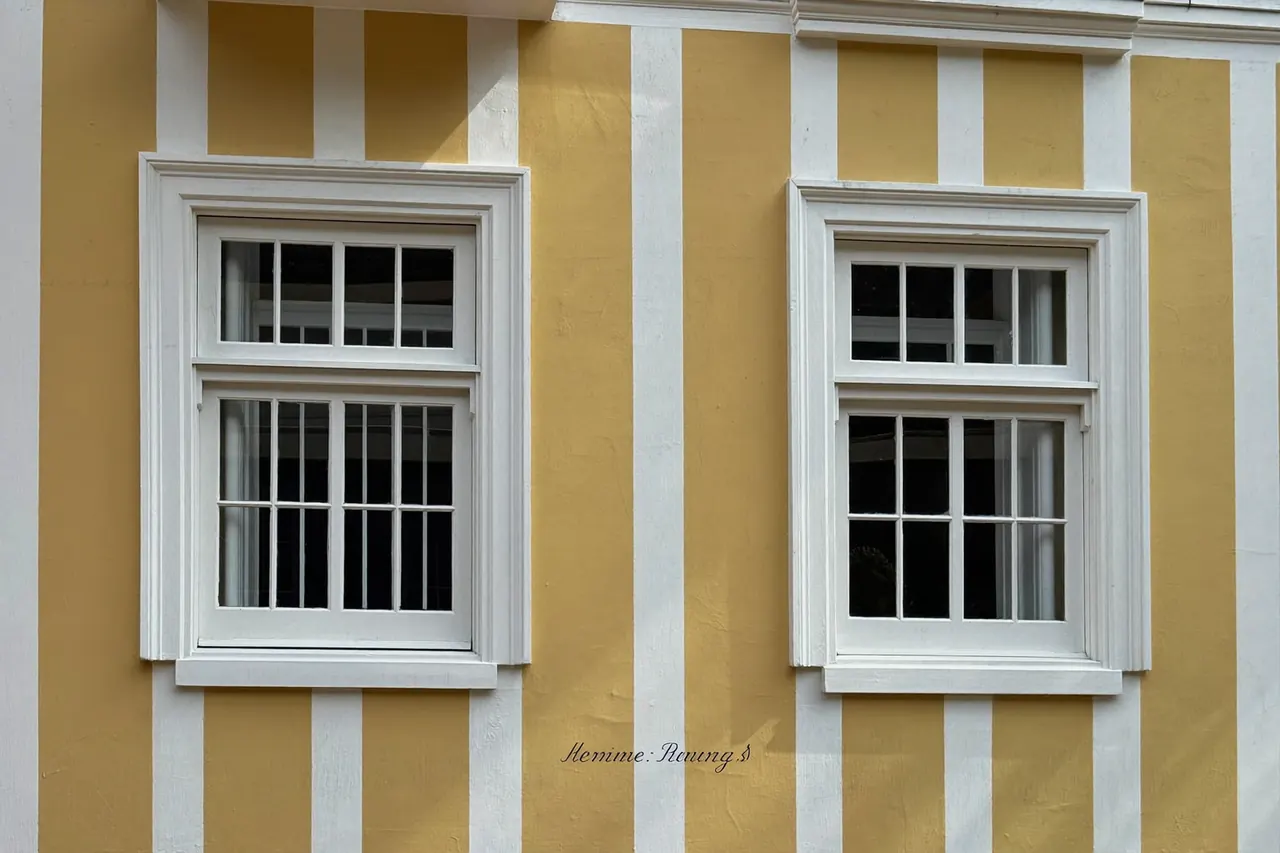 Original timber sash windows on the front of a listed building