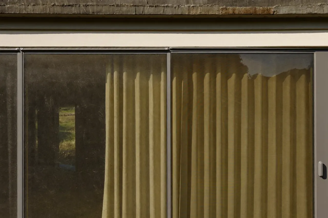 Rainwater beading and running off a self-cleaning glass coating