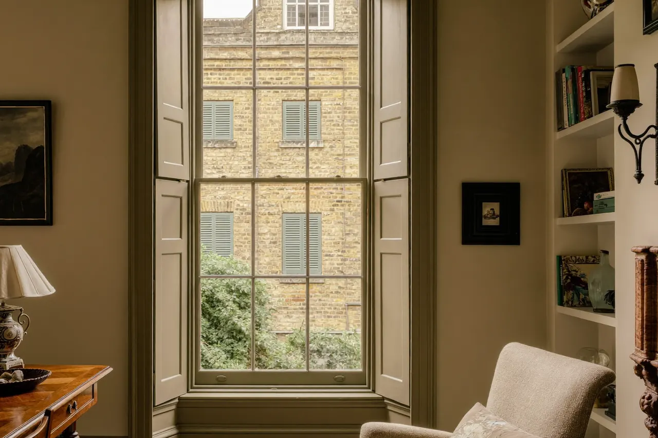 Secondary glazing panels fitted across a period bay window